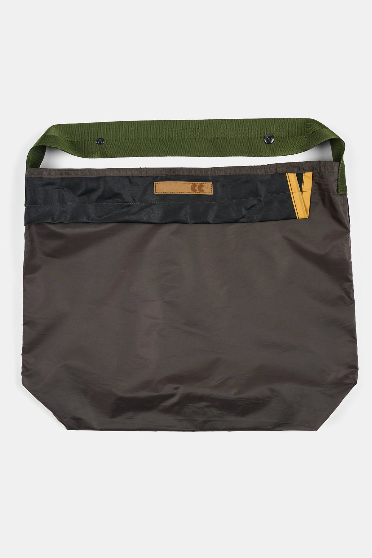Brown bag with green handle on a white background