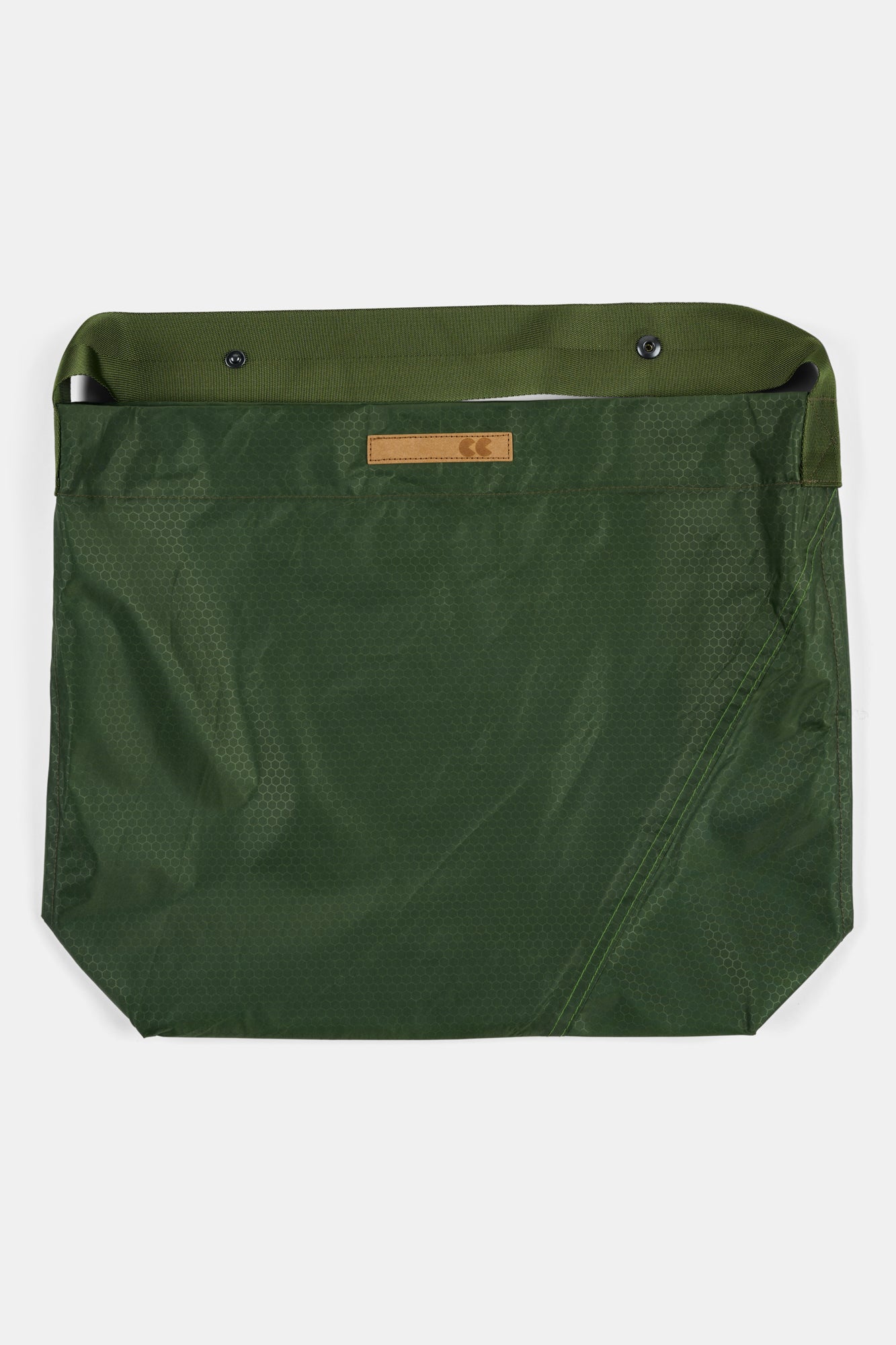 Green bag with a visible brand label on a white background