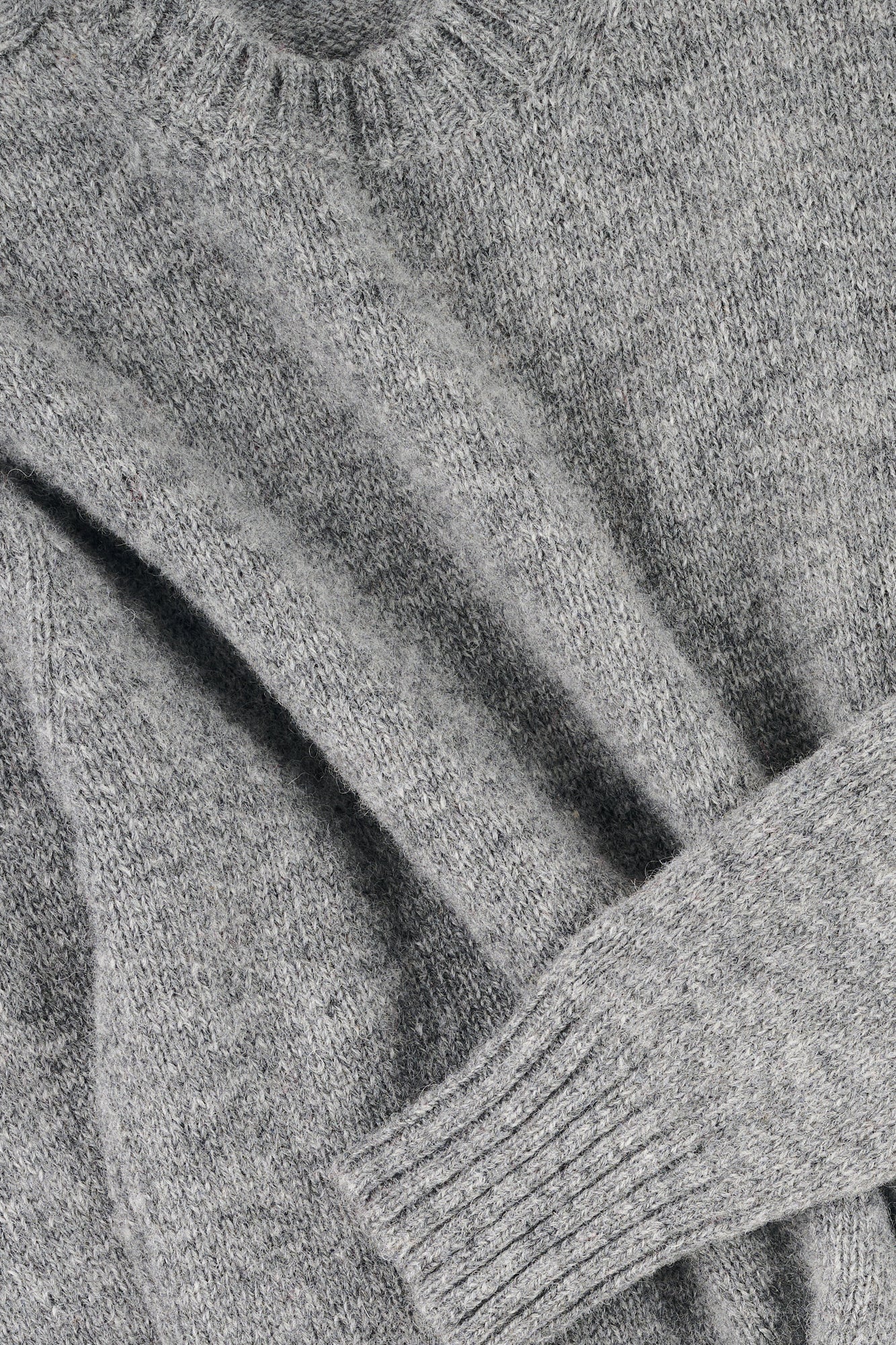 Close up of grey marl knit jumper