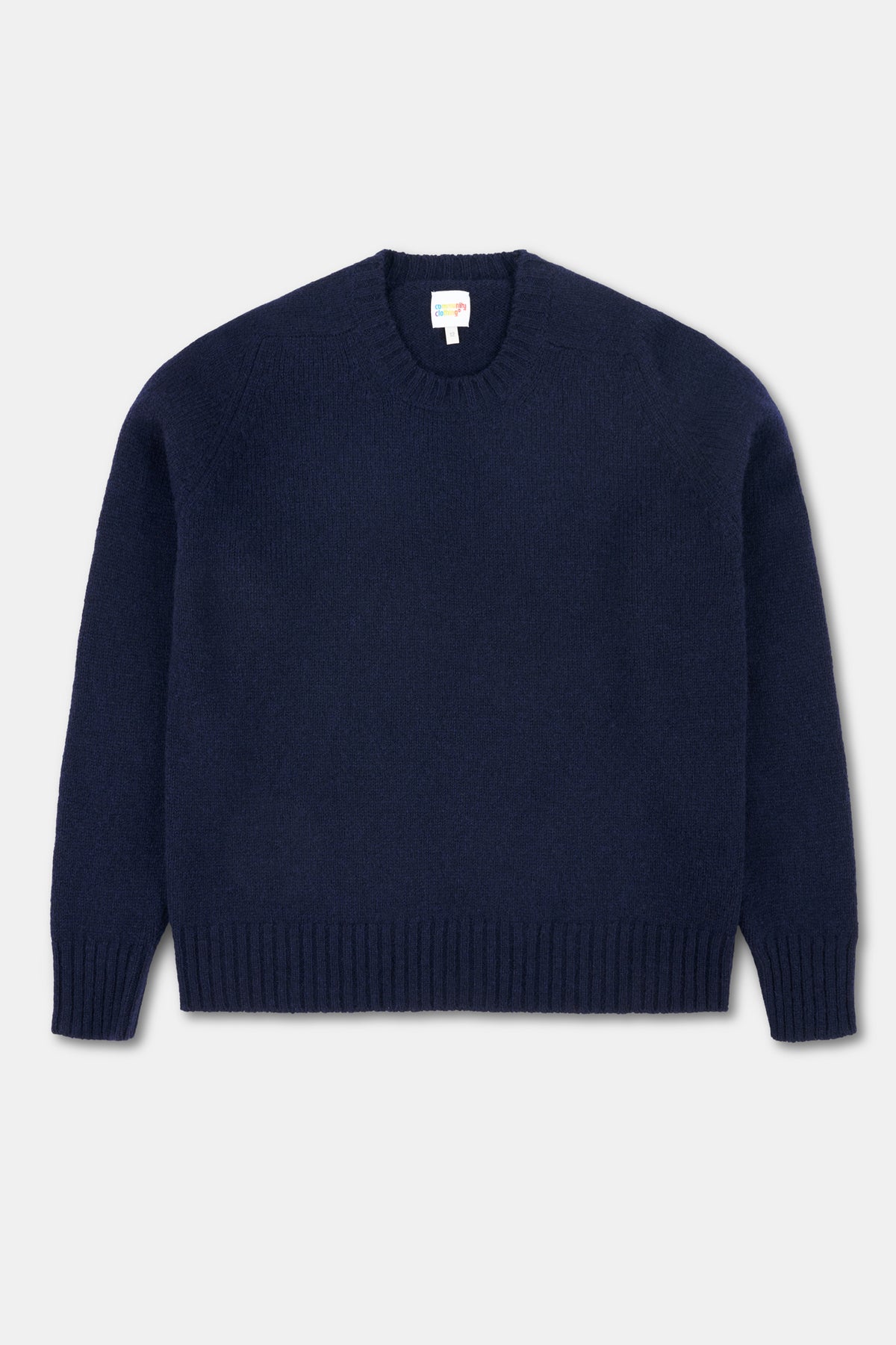 Navy shetland jumper on a white background