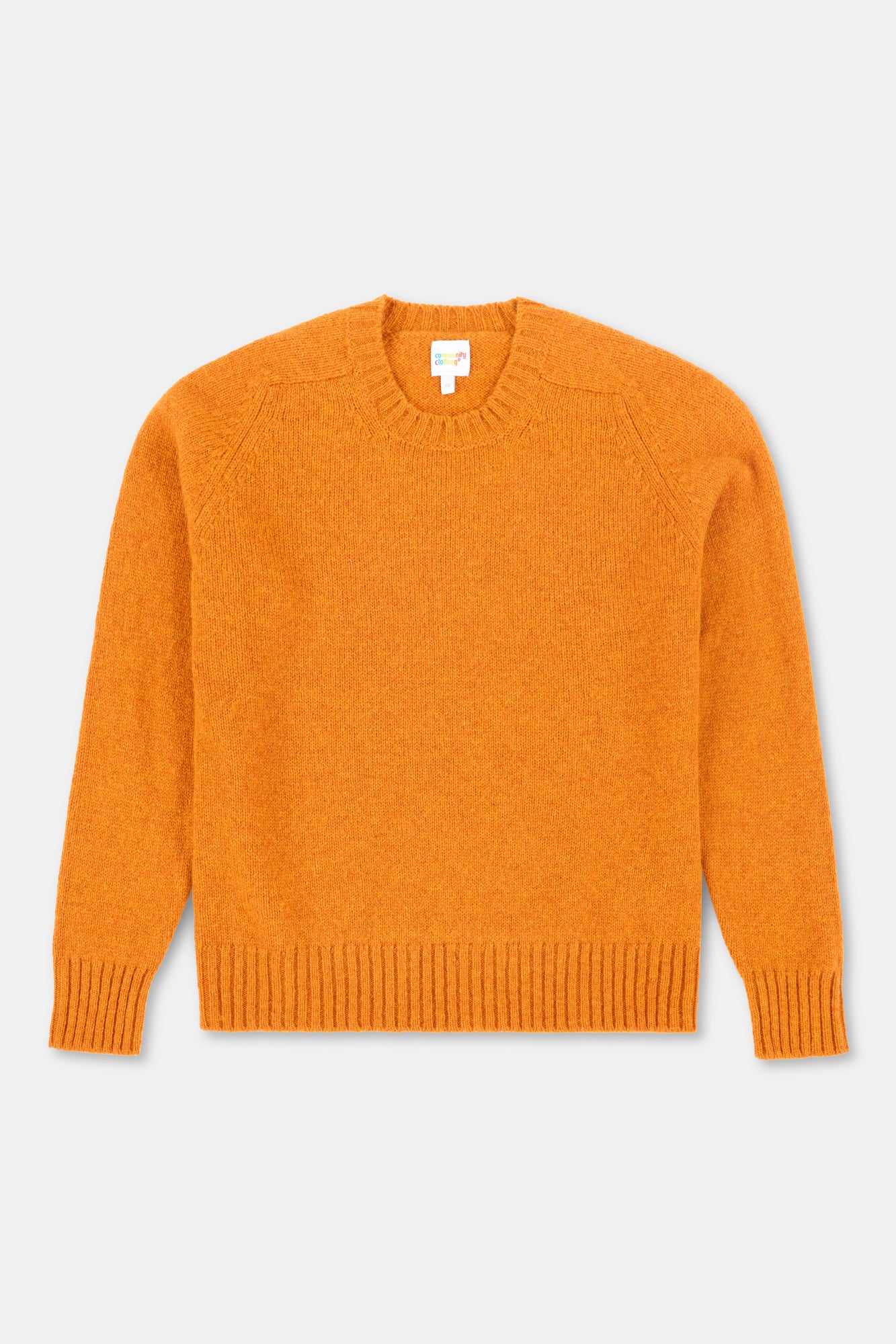 Orange sweater on a light gray background