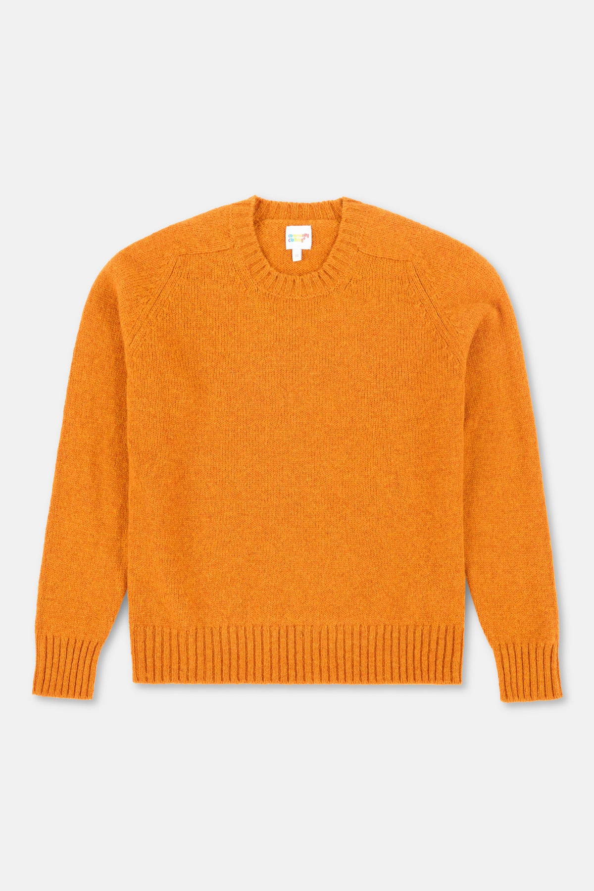Orange sweater on a light gray background