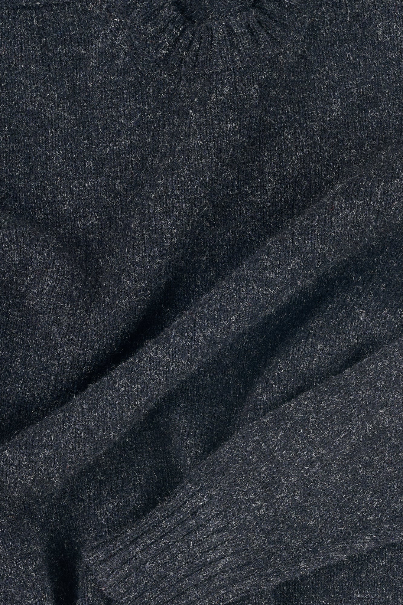 detail of charcoal marl knit shetland jumper with ribbed hems
