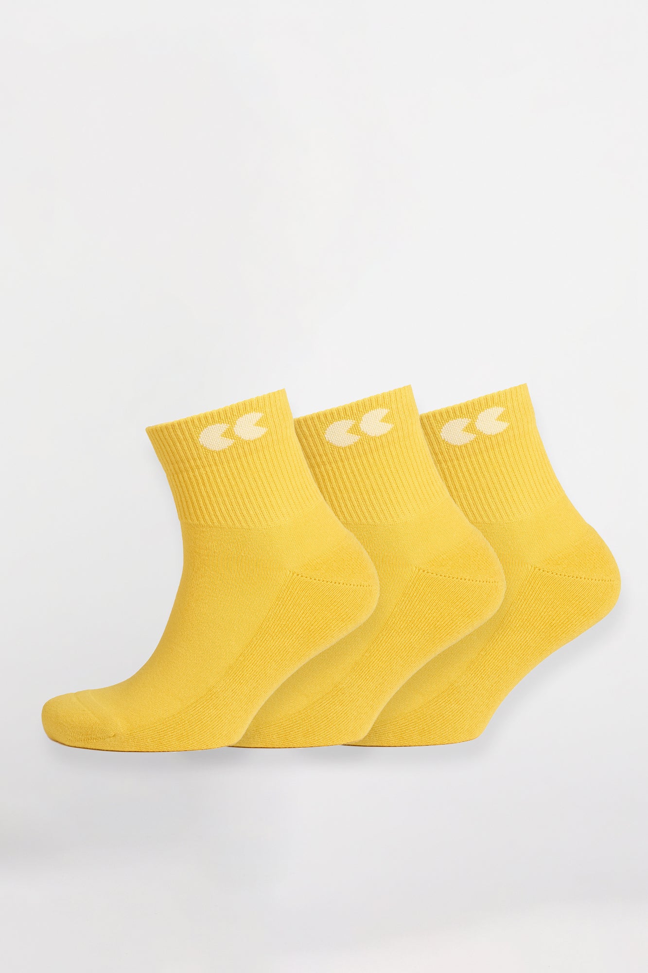 Unisex sports ankle socks in canary yellow worn with Community Clothing x Walsh Trainers in white