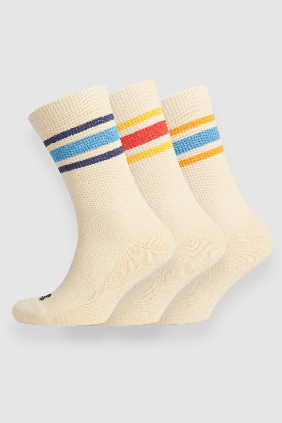 Three pairs of cream socks with colorful stripes on a light gray background