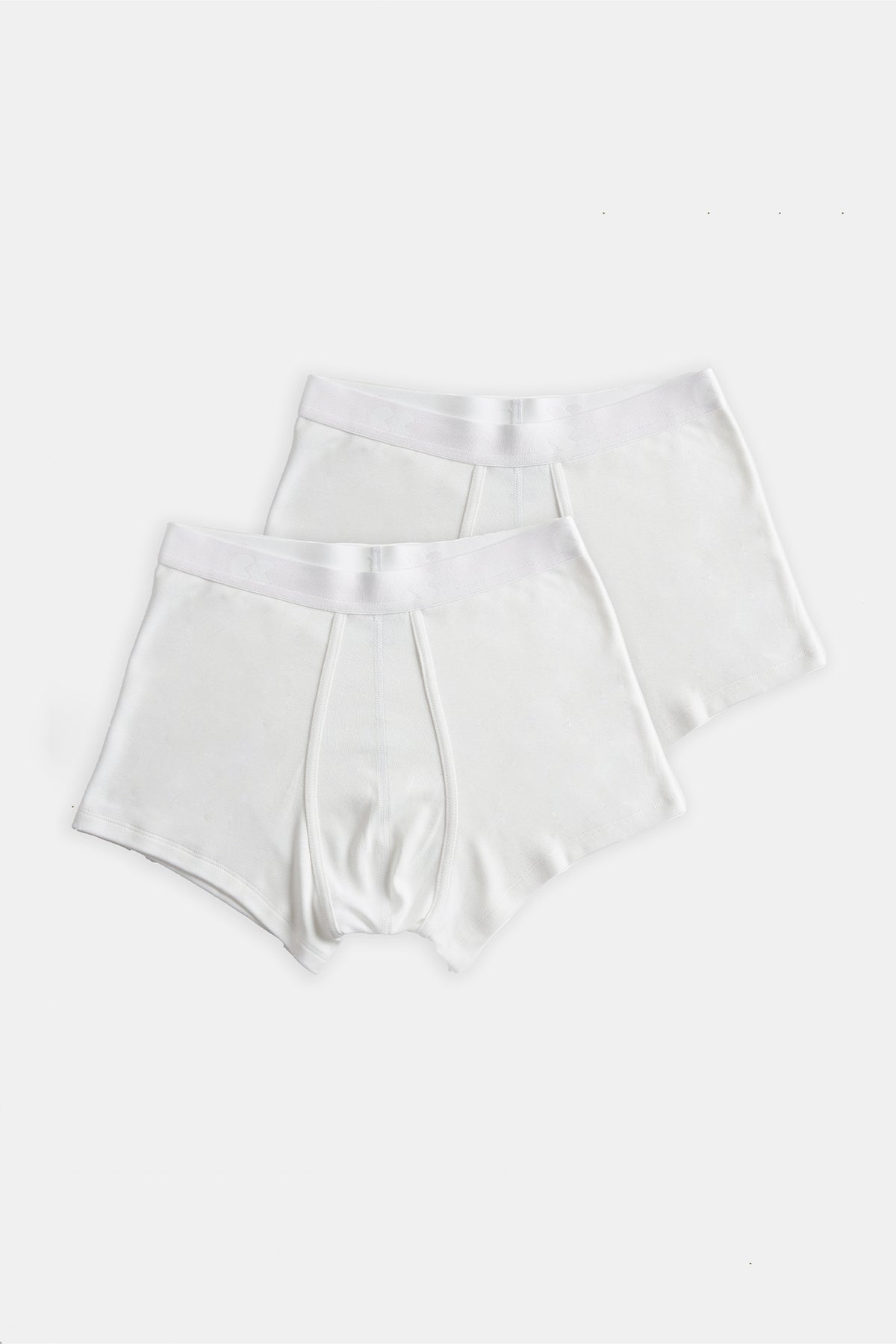 A pair of mens white briefs, shot flat lay.