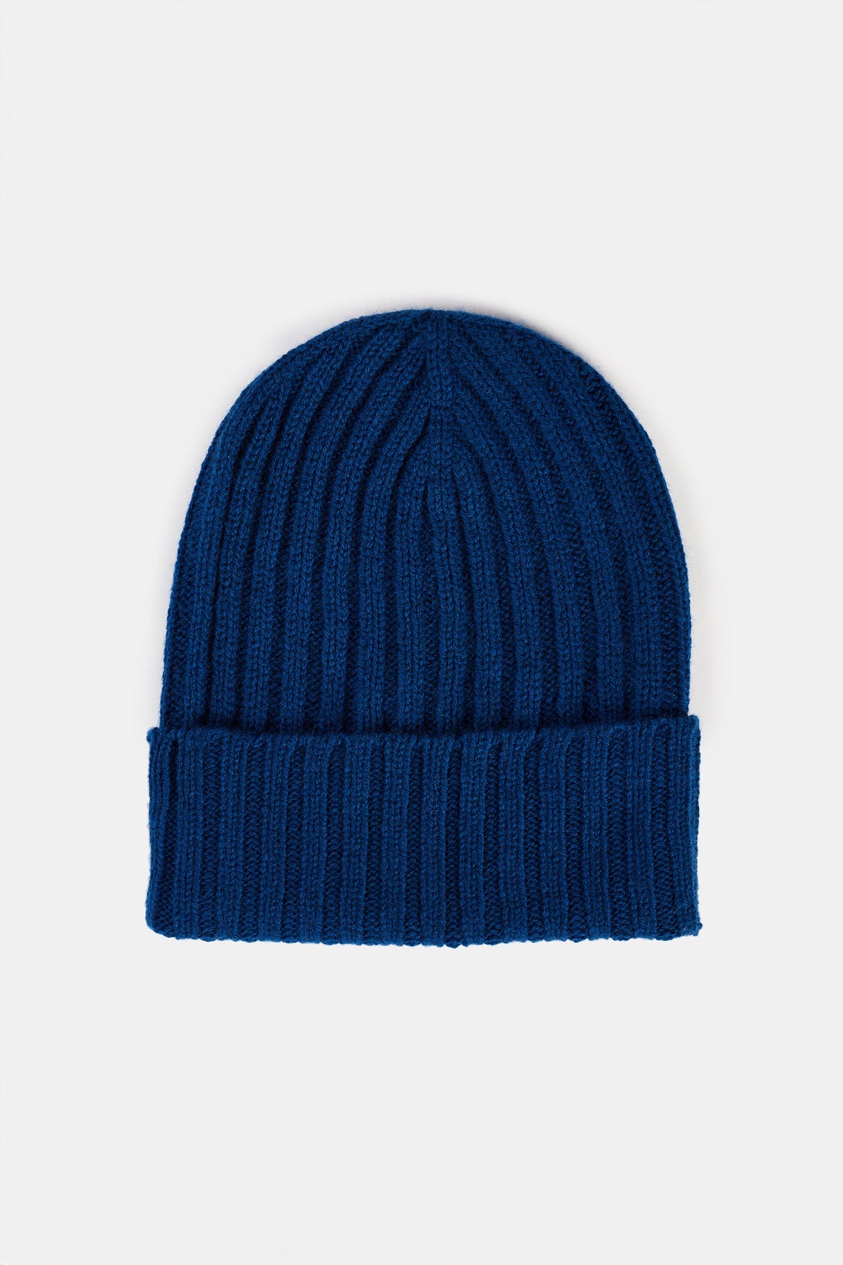 
            Bright blue beanie hat flatlay