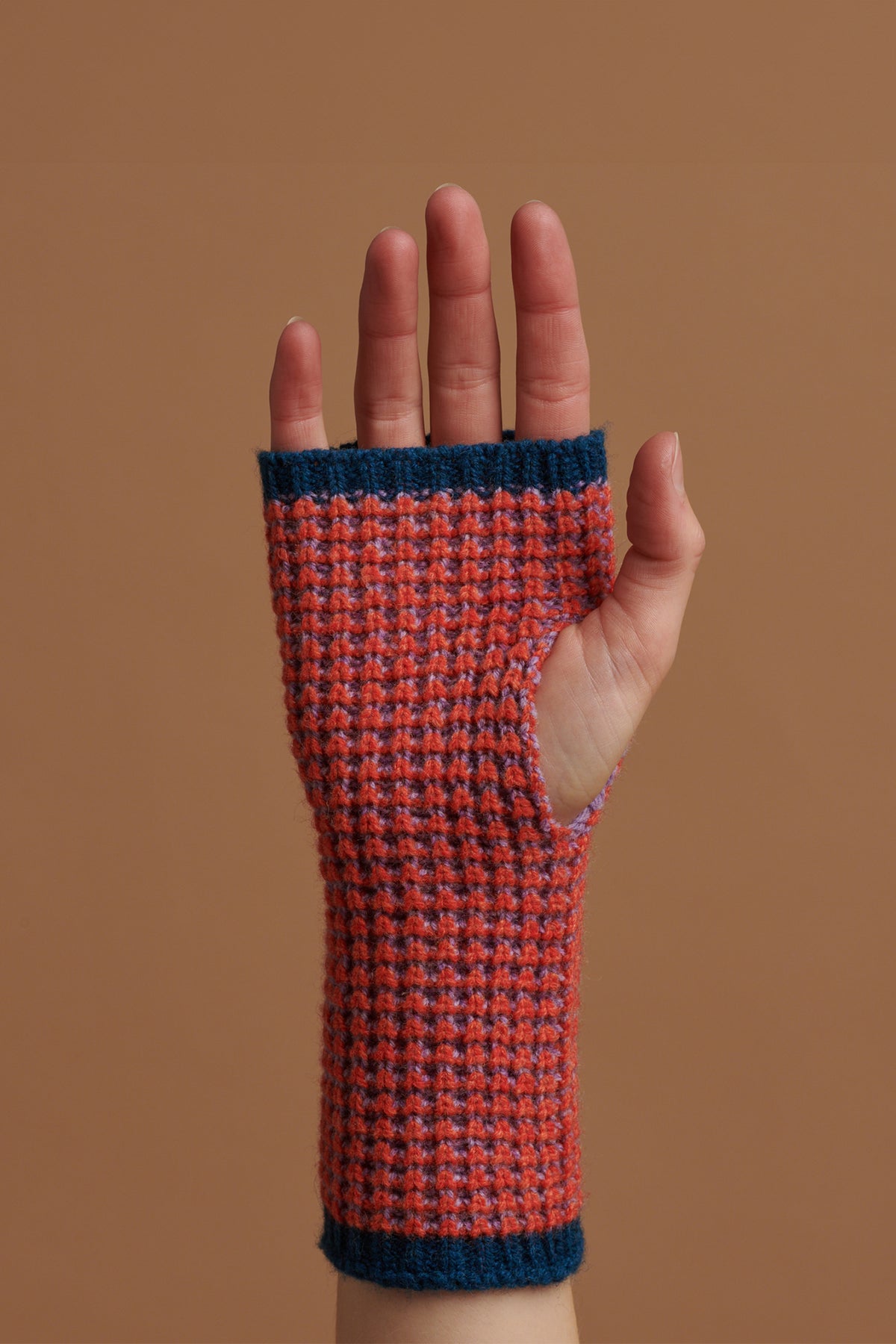 
            A hand wearing fingerless waffle gloves in flame