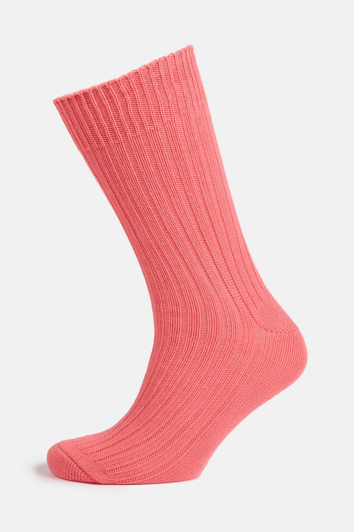 Ghost mannequin shot of a community clothing premium ribbed cotton sock in salmon pink