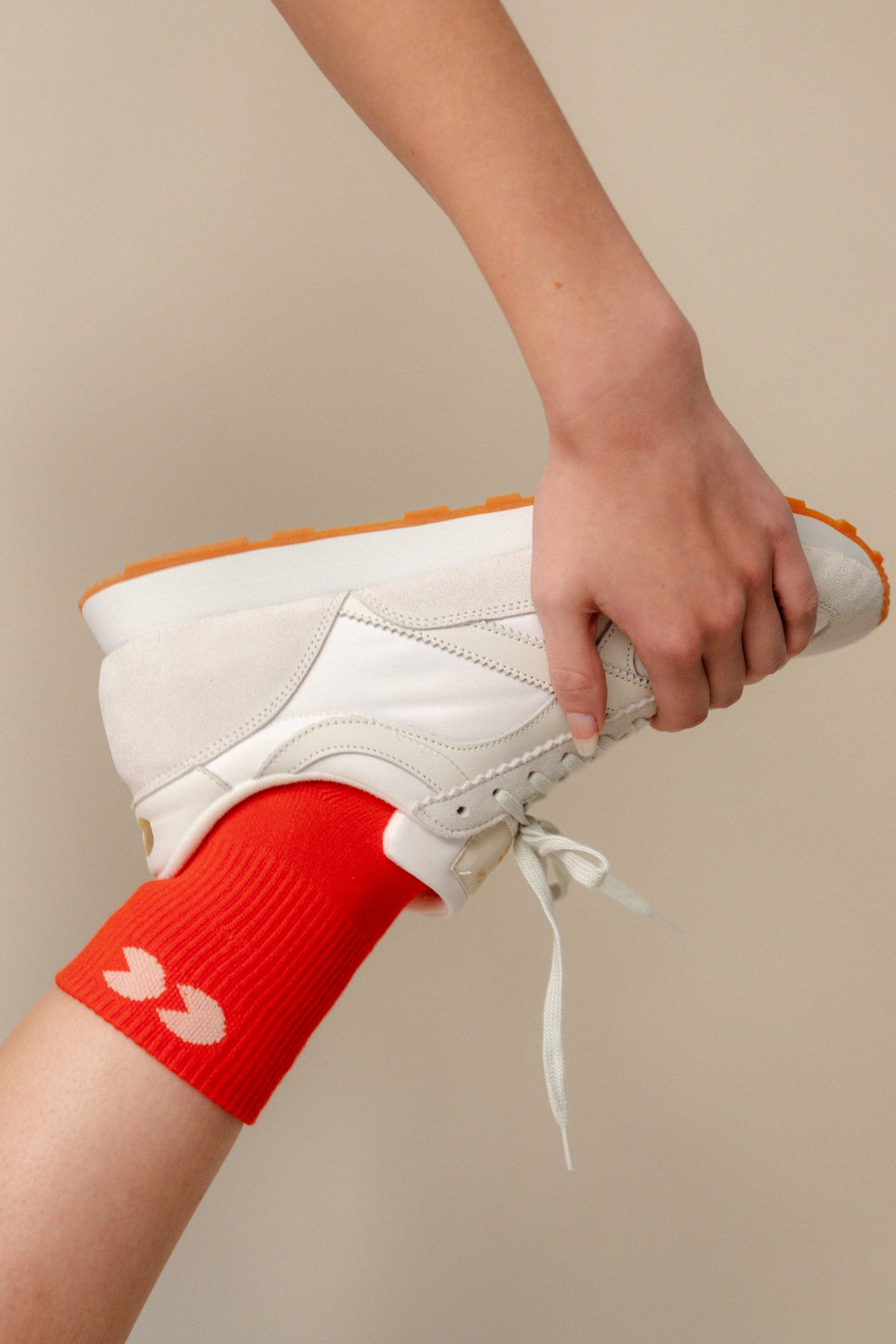 
            Flame red sports ankle socks worn with Community Clothing x Walsh trainers in white