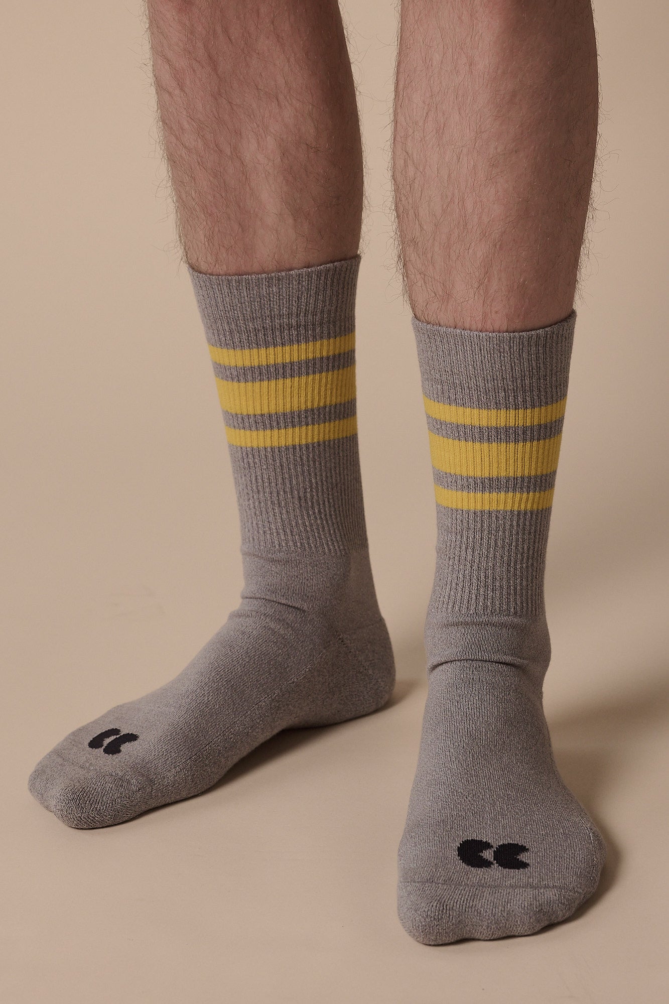 model wearing sport cotton sock calf 3 pack in grey and canary yellow stripe