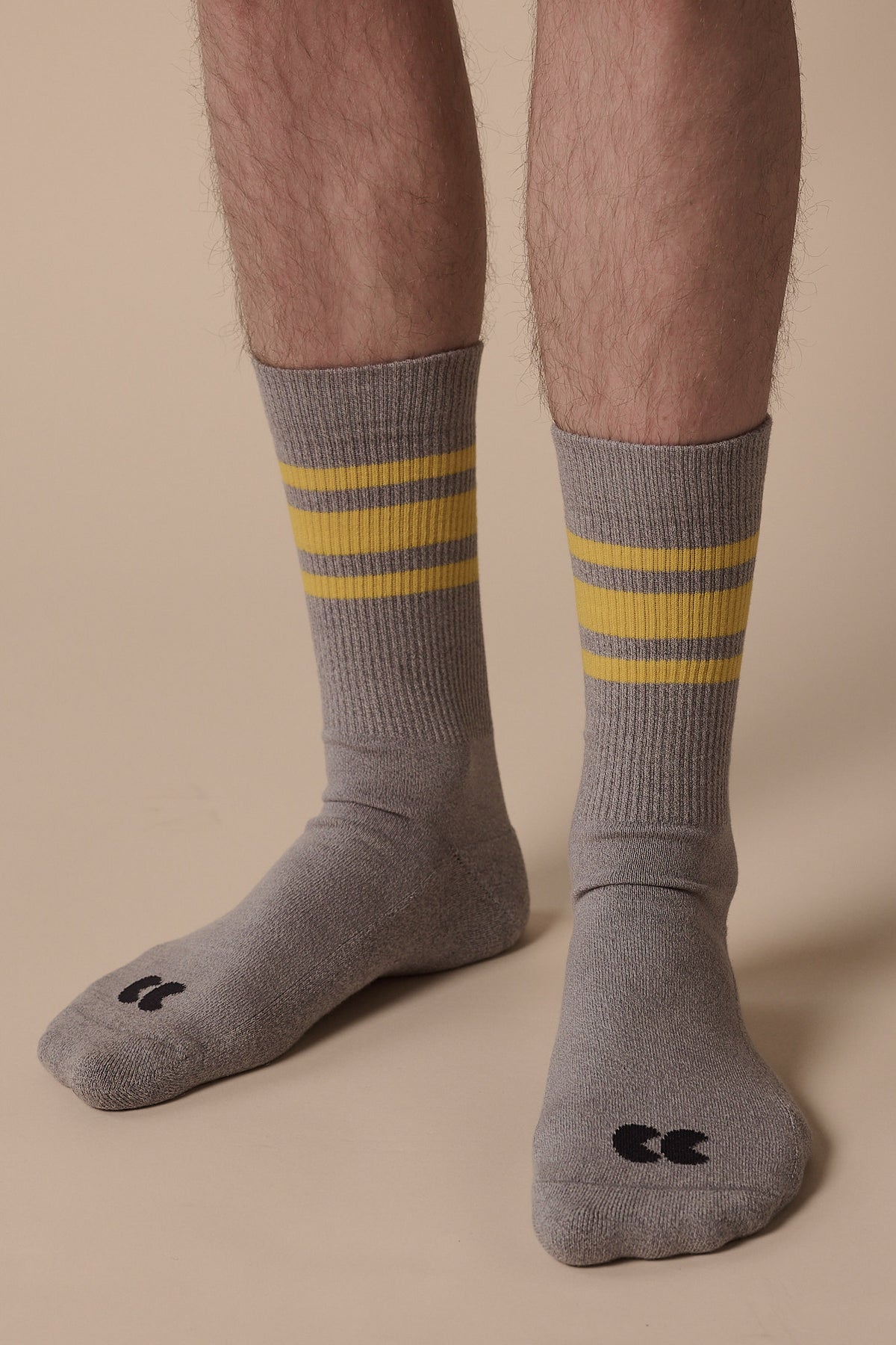 
            model wearing sport cotton sock calf 3 pack in grey and canary yellow stripe