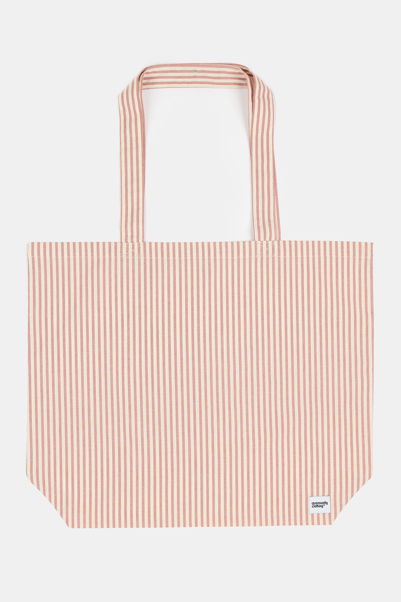 Female wearing quarry bank mill stripe tote bag in red and white stripe with small Community Clothing logo in the bottom right corner of the bag