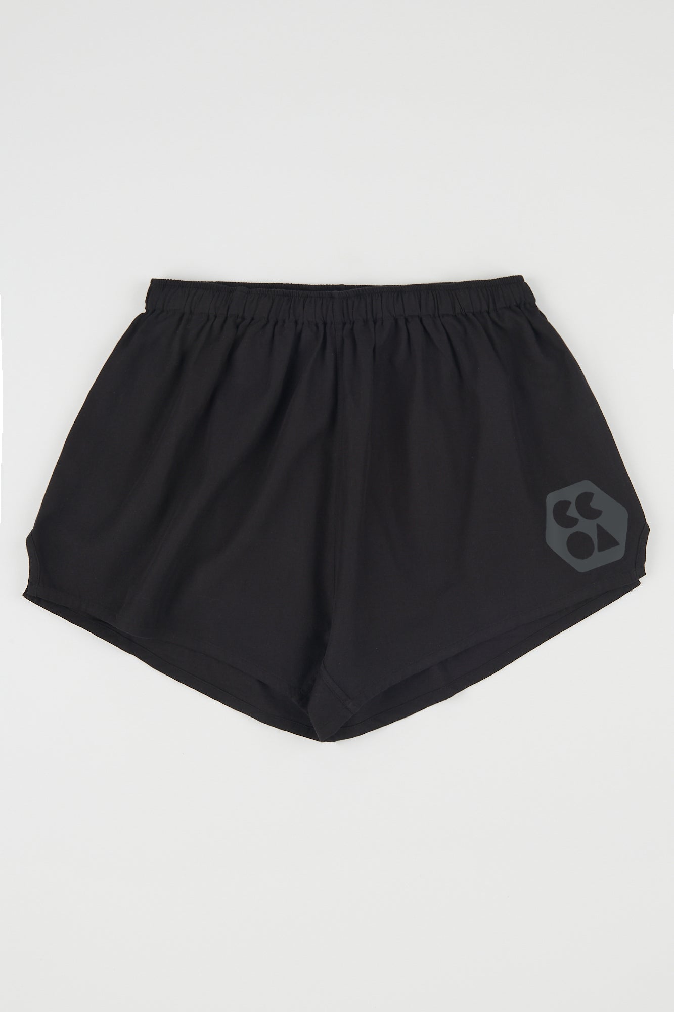 Flatlay product shot of women's lightweight sports short plastic free in black with CCOA logo
